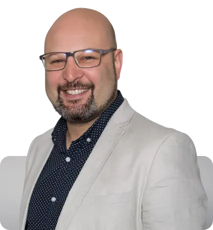 Portrait of Daniel from Key Finance, smiling in a light blazer and glasses