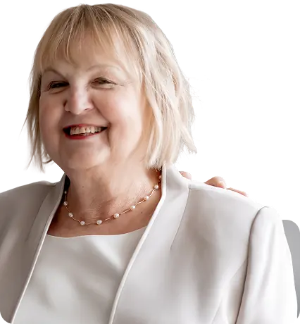 Portrait of Marianne from Key Finance, smiling in a cream jacket with a pearl necklace