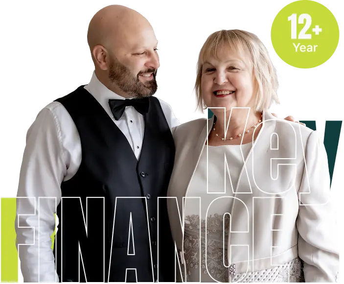 Daniel and Marianne of Key Finance together beside a 12 plus years badge